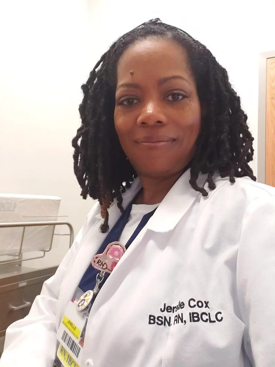 Nurse Jerelle Cox in her white coat